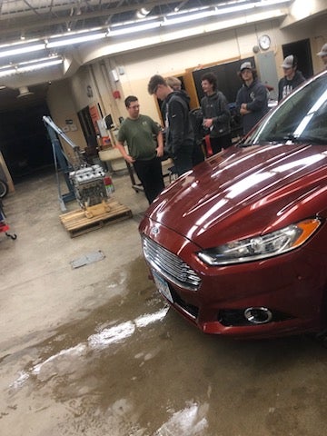 Warren-Alvarado-Oslo students working on donated vehicle by C&M