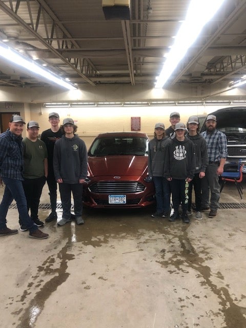 Warren-Alvarado-Oslo students working on donated vehicle by C&M